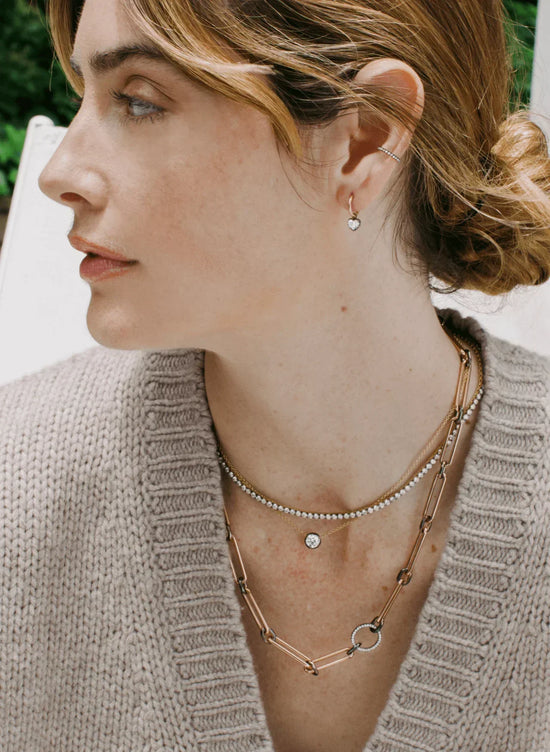 Vintage inspired Bouton lab-grown diamond heart shape gold hoop earrings in Georgian-style button-back setting on model