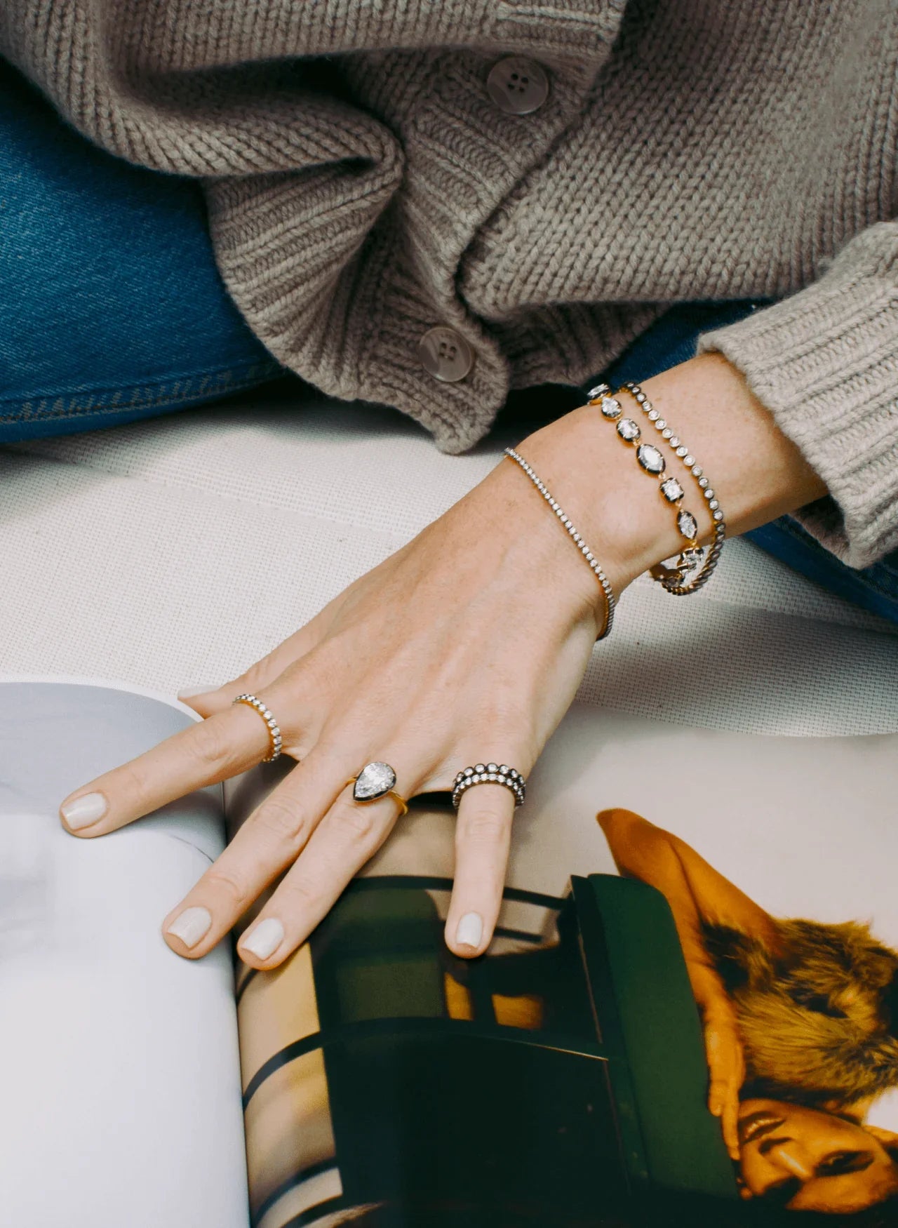 Bouton Lab-Grown Pear Shape Diamond Button Back Ring 3.6 ctw in 18kt gold front view on hand flipping magazine