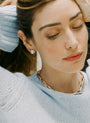 Bombé Lab-Grown Diamond Stud Earring in gold on model in blue