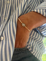 Georgian inspired Torque 18kt gold bangle with lab-grown oval diamond solitaire on wrist