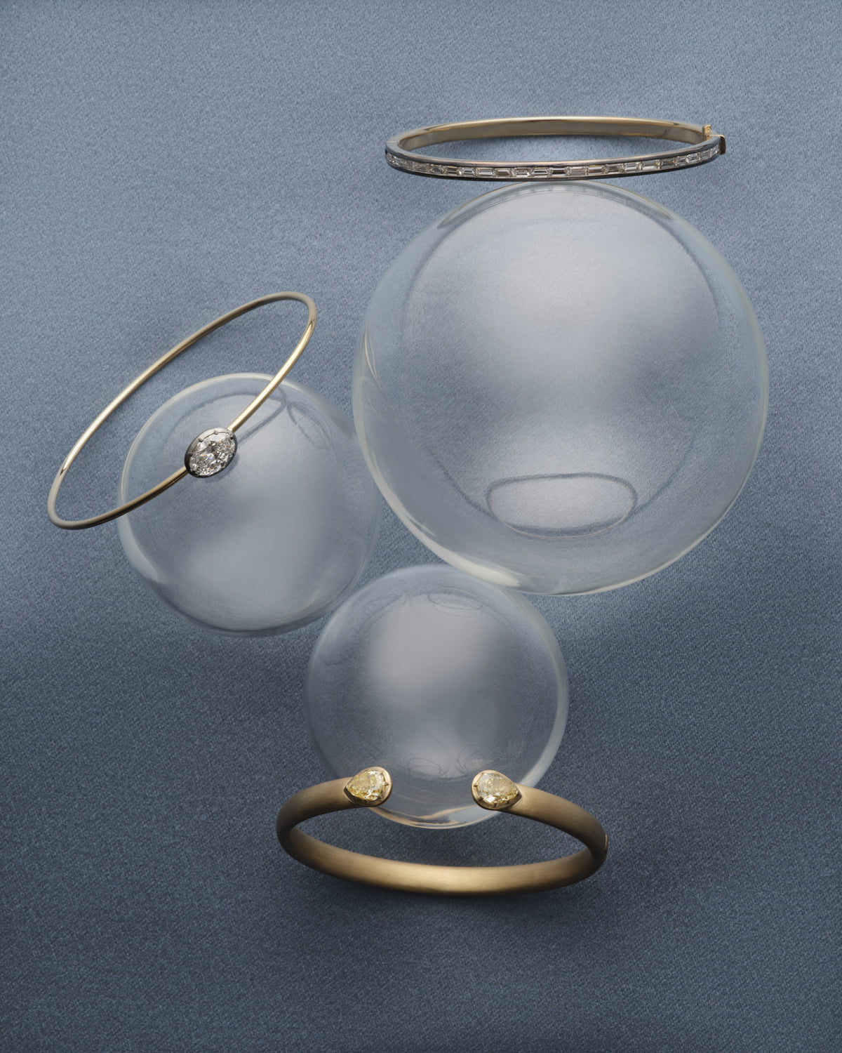 Bangles with glass spheres on blue silk