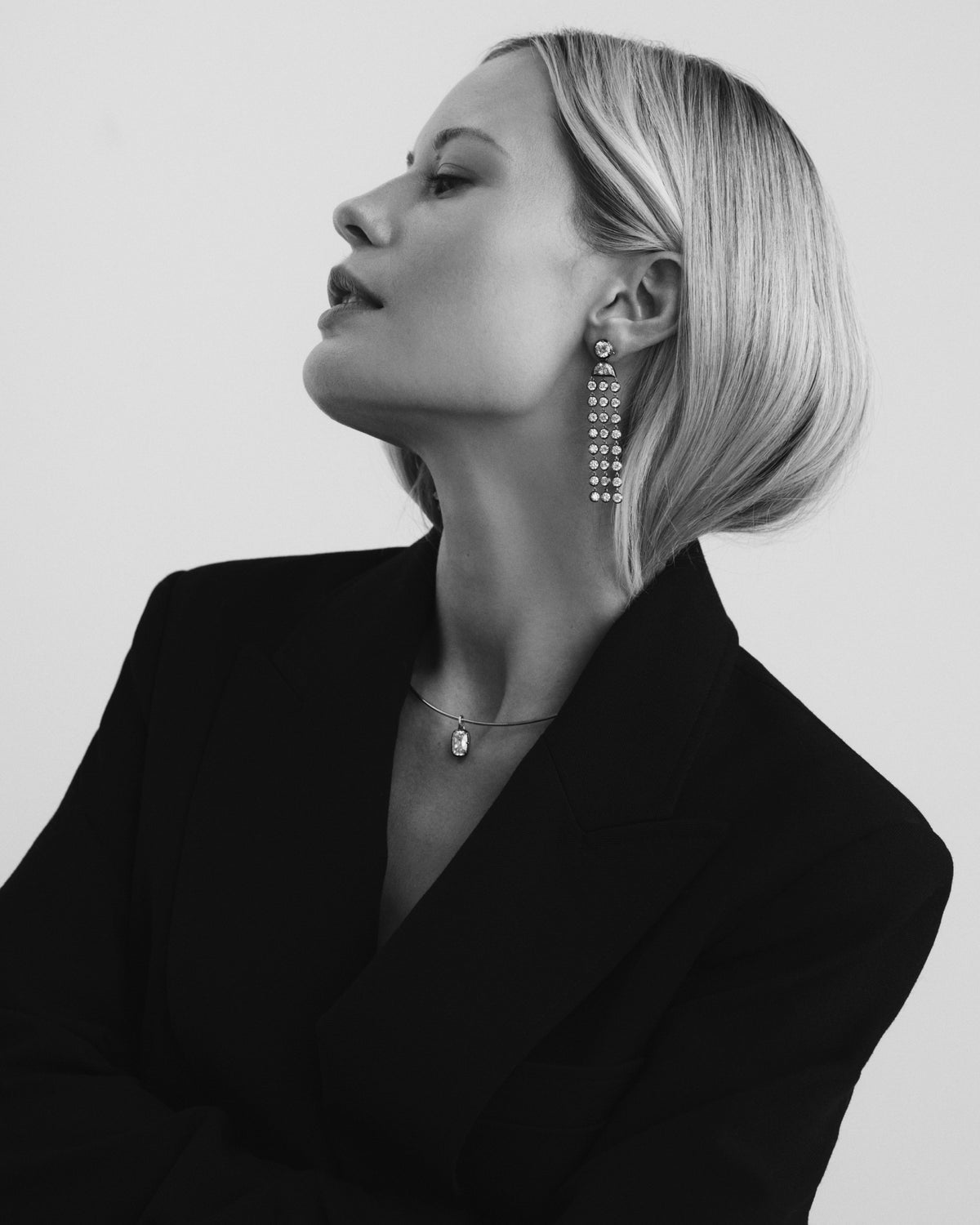 Black and white portrait in a blazer wearing drop earrings