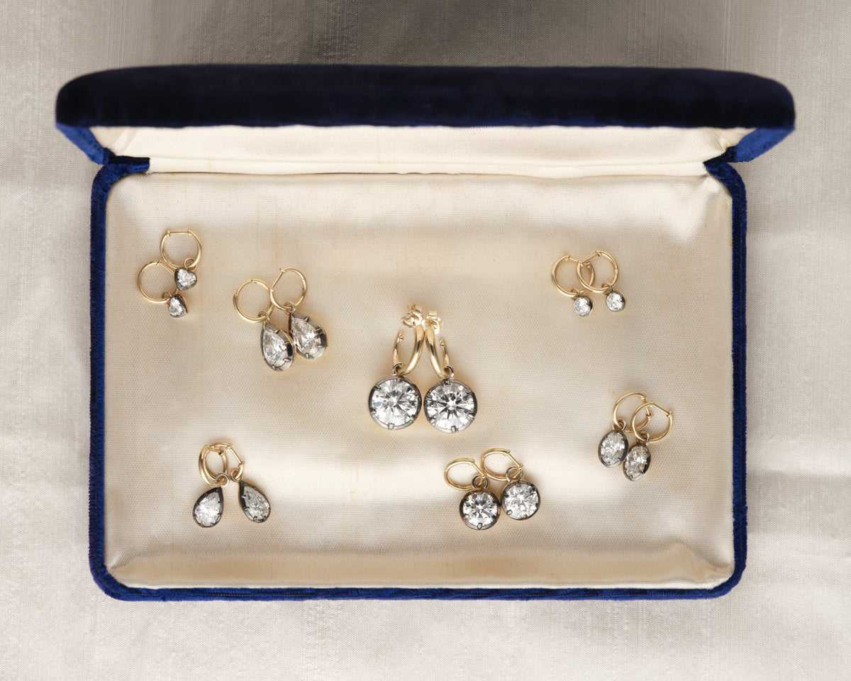 Diamond earrings in a vintage navy jewelry box