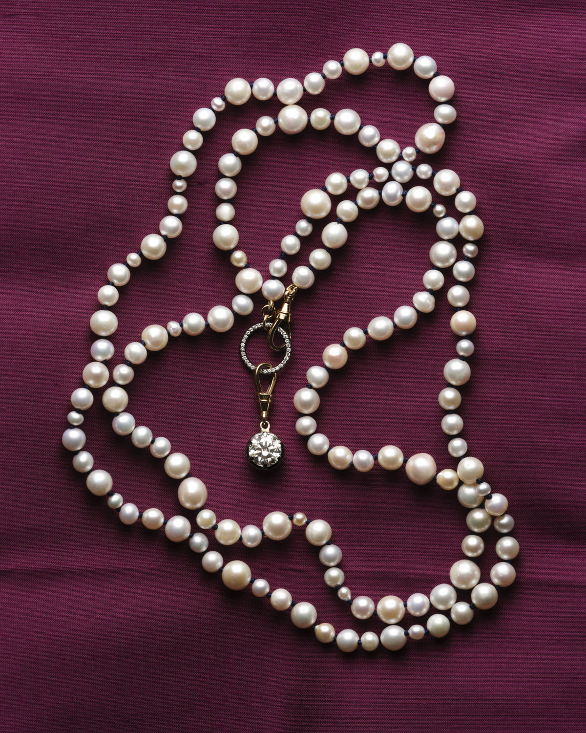 Pearl strands on magenta velvet