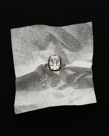 Lab-grown diamond ring resting on crumpled silver foil